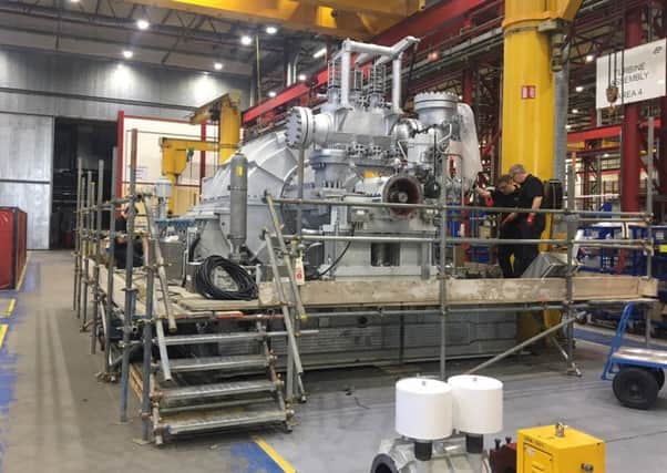 Engineeers work on the 45 tonne steam turbine.