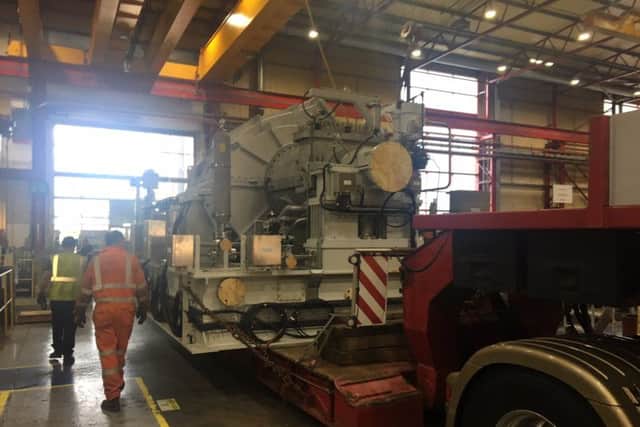 The steam turbine is lowered onto a lorry at the Peter Brotherhood factory.