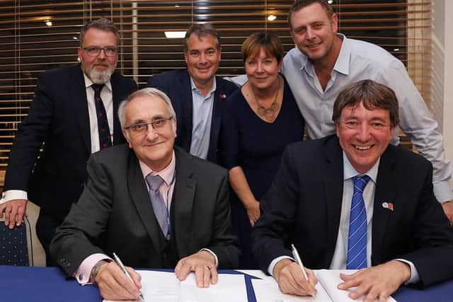 Peterborough United owners and Peterborough City Council officials sign the papers that move the football club much closer to buying the ABAX Stadium back.. Front row, left to right, cllr John Holdich, Dr Jason Neale, back, Cllr David Seaton, Stewart 'Randy' Thompson, PCC Chief Executive Gillian Beasley, Darragh MacAnthony. Photo: Joe Dent/theposh.com.