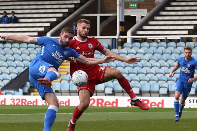 Jason Naismith shoots on goal while under pressure from Nick Anderton. Photo: Joe Dent