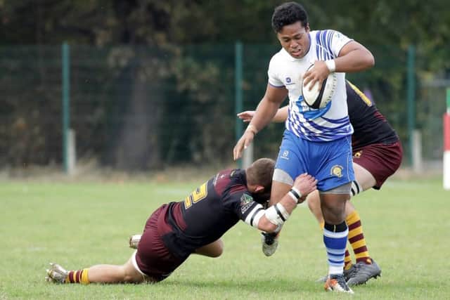 Lions centre Suva Ma'asi is tackled against Huddersfield. Picture: Mick Sutterby