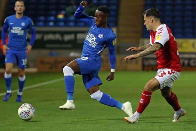 Siriki Dembele of Peterborough United takes on Ross Wallace of Fleetwood Town. Photo: Joe Dent/theposh.com