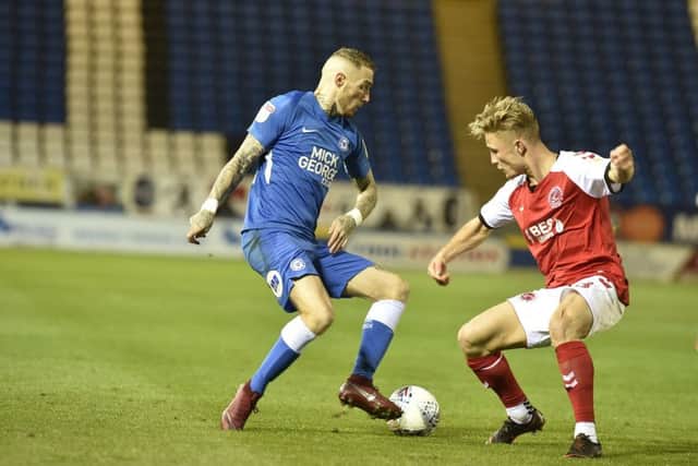 Posh winger Marcus Maddison takes on a Fleetwood defender. Photo: David Lowndes.