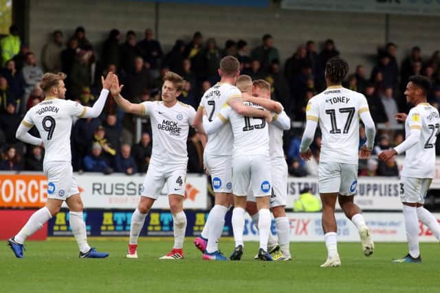 Posh players celebrate Joe Ward's goal at Burton. Photo: Joe Dent/theposh.com.