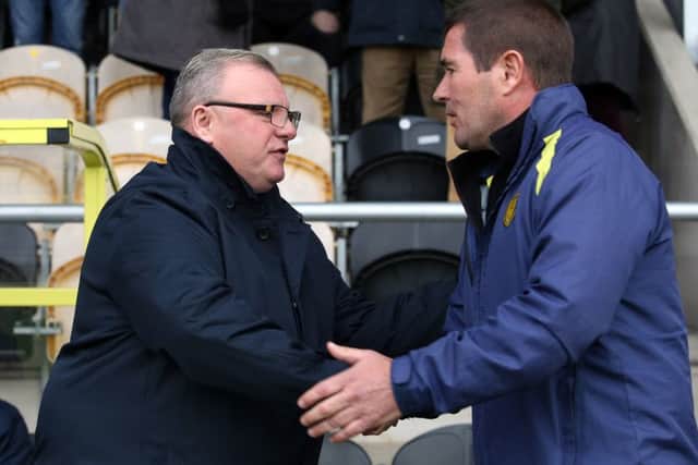 Posh manager Steve Evans greets Burton boss Nigel Clough before the game. Photo: Joe Dent/theposh.com.