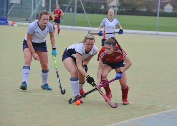 City of Peterborough Ladies in action (red).