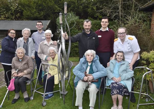 Sculptor Kurt Lightfoot from Orna-Metal UK with his bird feeder installed in the garden at  Florence House care home, Park Road. He is joined in the garden by residents and staff at the House EMN-181031-082907009