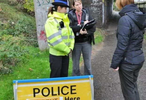 Police carry out investigations at the scene of the alleged attacks