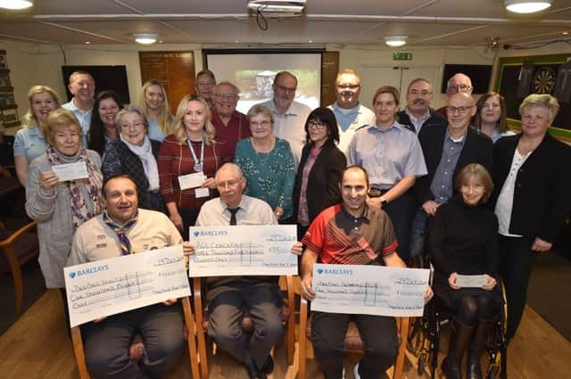 Deeping raft race cheque recipiants with raft race committee members at the presentation at Deeping Rugby Club. EMN-181029-231136009
