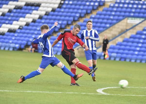 Action from last season's PFA Senior Cup final between Netherton (red) and Moulton Harrox.