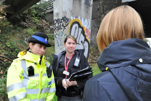Police officers putting out notices and talking to passers-by on a walkway between Rhubarb Bridge at North Bretton - the scene of one of the attacks