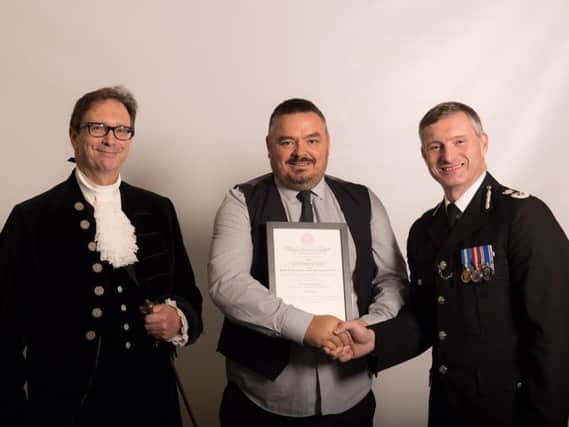 Darren Peace, (centre) receiving his award from from the High Sheriff of Lincolnshire (left) and the Chief Constable of Lincolnshire Police (right)