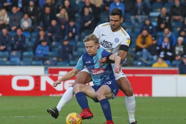 Ryan Tafazolli of Posh challenges Wycombe's Alex Samuel. Photo: Joe Dent/theposh.com.