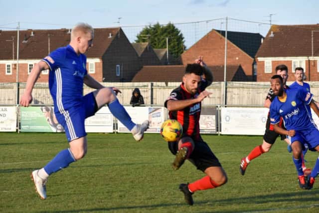 Lewis Hilliard (blue) in action for Peterborough Sports against Thame at the weekend. Photo: James Richardson.