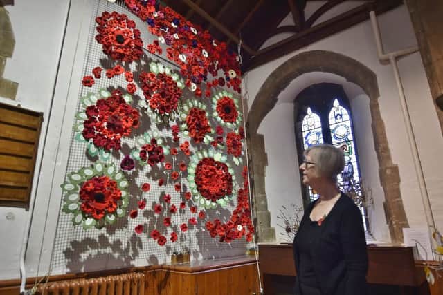 WW1 exhibition at Longthorpe Church.      Jane Hogg  with the hand made poppy display EMN-180411-204057009