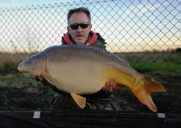Big fish angler Andy Mason is pictured with a huge carp taken from the Lapwing Pool at Float Fish Farm recently.