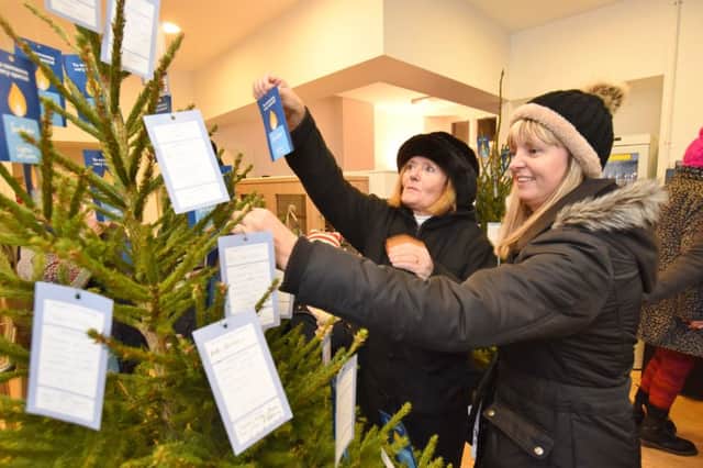 Lights of Love service 2016 at Sue Ryder Thorpe Hall .  Julia Thomas and Sally Tattersall putting messages on the Lights of Love tree EMN-161112-194254009