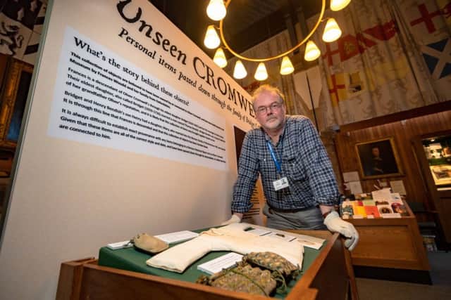 Curator and museum manager Stuart Orme Swith Oliver Cromwell artefacts. Photo: SWNS