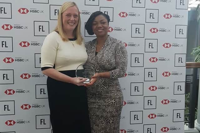Joanne Bass, left, with her award presented by Griselda Togobo.