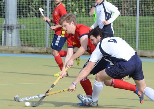 Danny Sisson (red) hit the post for City of Peterborough at Oxted.