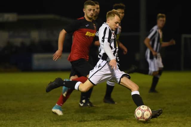 Sam Wilson (stripes) of Peterborough Northern Star in action against Sleaford Town. Photo: Chantelle McDonald. @cmcdphotos.