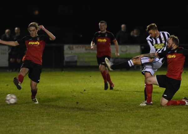 Jake Sansby (stripes) of Peterborough Northern Star  scores against Sleaford Town. Photo: Chantelle McDonald. @cmcdphotos