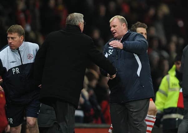 Sir Alex Ferguson (left) and Steve Evans shake hands after an FA Cup tie at Old Trafford in 2011.