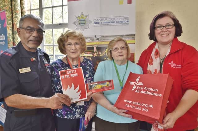 Peterborough Pensions  vice chairman  Beryl Martin and chairman  Rita Young with Abi Hirji and Tammy Swiderski from the East Anglian Air Ambulance at the Dignity In Old Age exhibition at the Town Hall. EMN-180711-140928009