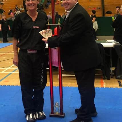 Sarah Ward collects her trophy and prizemoney from Andrew Hicks.
