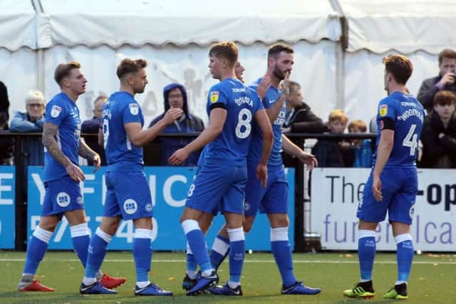 Posh players celebrate their first goal at Bromley. Photo: Joe Dent/theposh.com.
