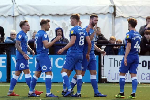 Posh players celebrate a goal at Bromley. Photo: Joe Dent/theposh.com.