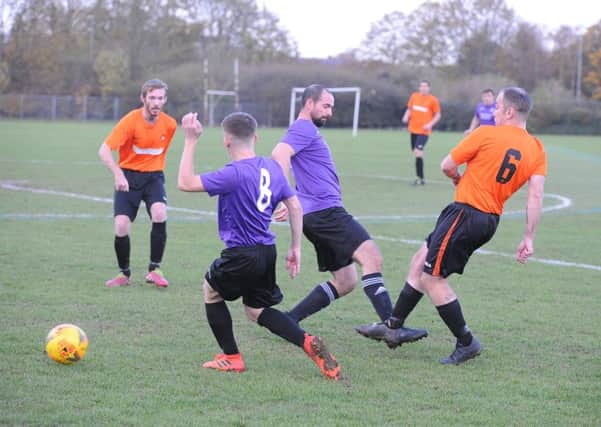 Action from Stanground Sports (purple) and Leverington Sports A. Photo: David Lowndes.