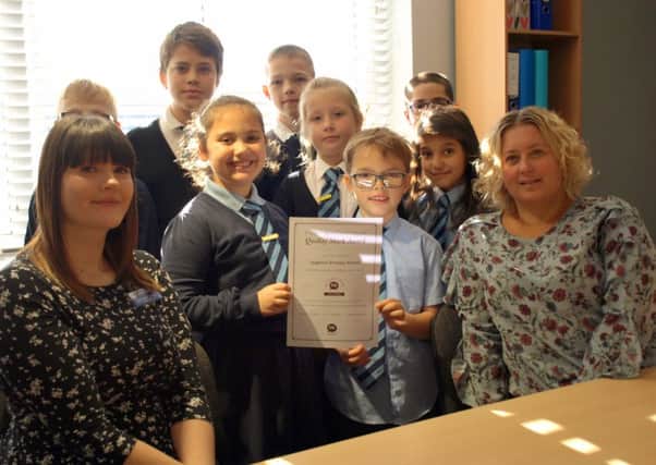 Pupils from Leighton Primary School with Natalie Guilfoyle, EAL leader (left) and head teacher Hayley Sutton (right).