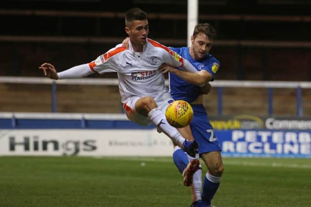 Darren Lyon of Peterborough United in action with Lloyd Jones of Luton Town . Photo: Joe Dent/theposh.com.
