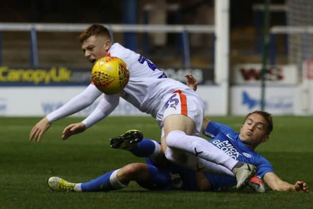Posh midfielder Louis Reed tackles Luton's Arthur Read. Photo: Joe Dent/theposh.com.