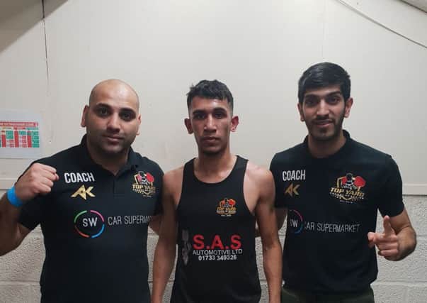 Fazan Khalid with coaches Hamad Javed (left) and Omar Shaheen (right).