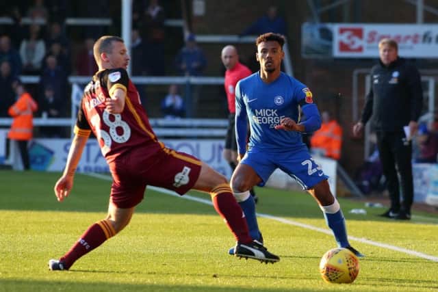 Posh full-back Tyler Denton plays the ball down the line against Bradford City. Photo: Joe Dent/theposh.com.