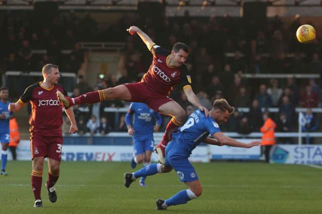 Posh striker Matt Godden is knocked down by Bradford's Ryan McGowan. Photo: Joe Dent/theposh.com.