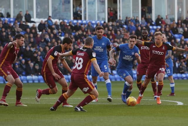 Posh midfielder Jamie Walker runs into a crowd of Bradford City defenders. Photo: Joe Dent/theposh.com.
