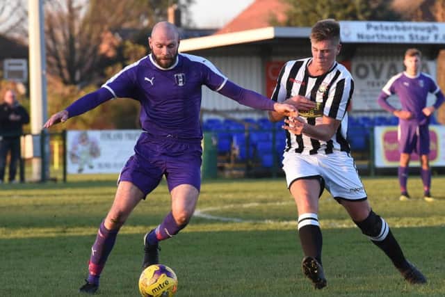 Harry Fitzjohn (stripes) of Peterborough Northern Star in action against Daventry. Photo: Chantelle McDonald. @cmcdphotos