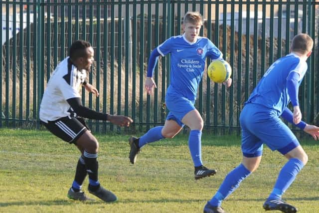 Action from a draw in the Peterborough Premier Division between Whittlesey Athletic (blue) and Long Sutton Athletic. Photo: David Lowndes.