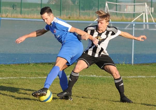 Action from Whittlesey Athletic's 3-3 draw with Long Sutton Athletic (stripes) in the Peterborough Premier Division. Photo: David Lowndes.