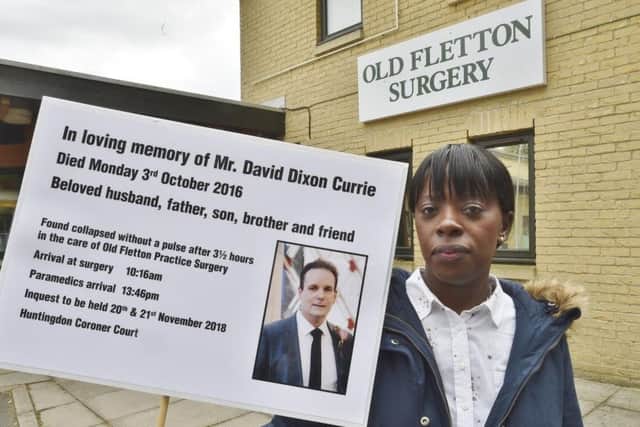Caroline Currie protesting outside Old Fletton Surgery about the death of her husband David Dixon-Currie