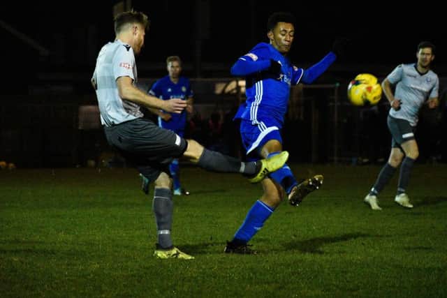 Dion Sembie-Ferris (dark blue) in action for Peterborough Sports against Bedford. Photo: James Richardson.