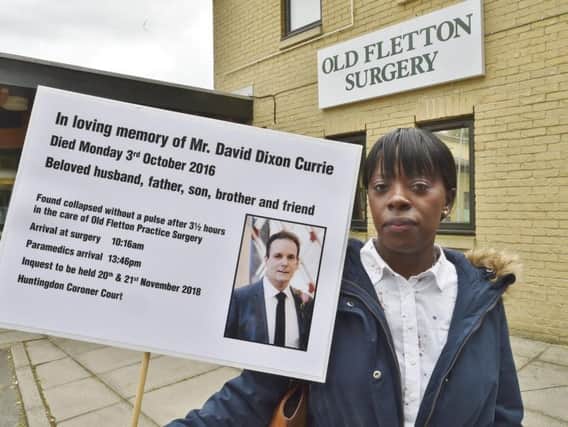Caroline Currie protesting outside Old Fletton Surgery about the death of her husband David Dixon-Currie