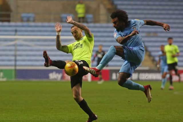 Posh winger Marcus Maddison blocks a cross from Coventry's Junior Brown. Photo: Joe Dent/theposh.com.