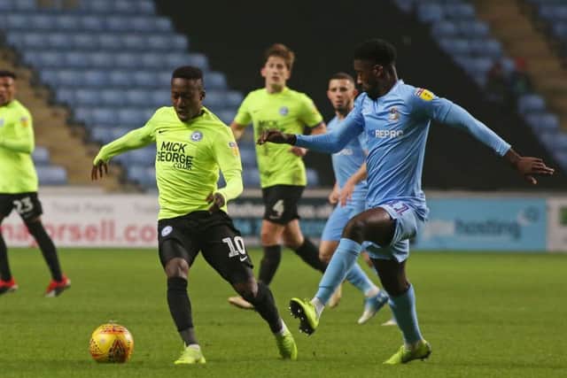 Siriki Dembele of Peterborough United in action with Jordy Hiwula of Coventry City. Photo: Joe Dent/theposh.com.
