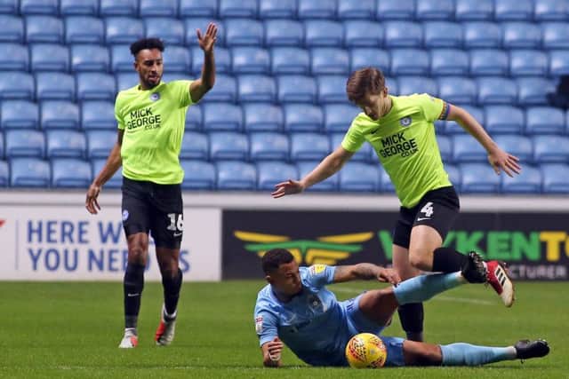 Posh skipper Alex Woodyard in action at Coventry as centre-back Rhys Bennett watches on. Photo: Joe Dent/theposh.com.
