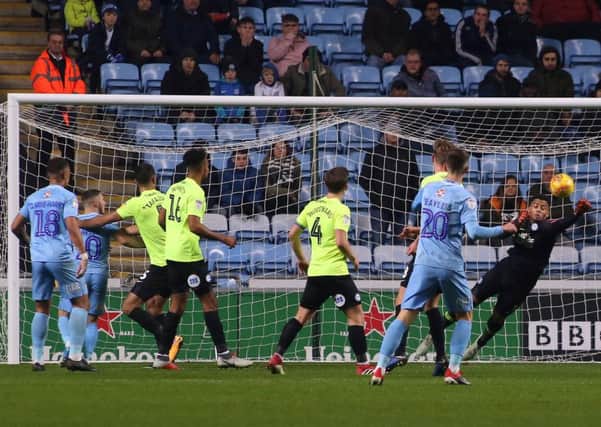 Posh goalkeeper Aaron Chapman punches the ball clear at Coventry. Photo: Joe Dent/theposh.com.