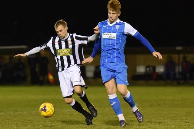 Sam Wilson (stripes) scored for Peterborough Northern Star at Cogenhoe.